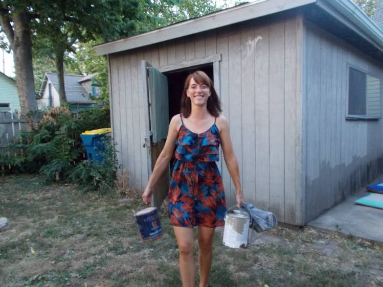 Sarah donating paint for the community art wall 