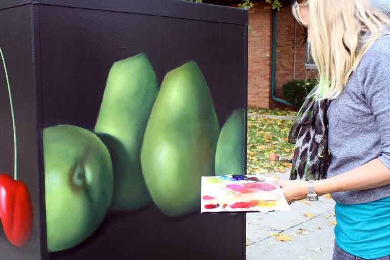Oil painter Rita Spalding at work on one of her signal boxes.