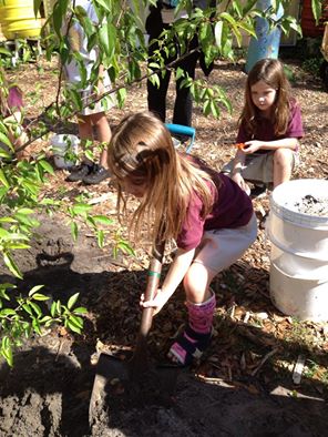 A child at  Learning Gate Community School prepares soil despite the cast on her leg. Thomas captions this photo “Our Hope For Mending a Broken Future.”
