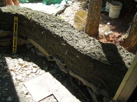 Wall taking shape on top of the stone foundation